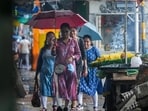 Pedestrians on a road during rain in Kolkata on Sunday. (PTI) Pedestrians on a road during rain in Kolkata on Sunday. (PTI)