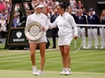 Czech Republic's Marketa Vondrousova celebrates with the trophy alongside runner up Tunisia’s Ons Jabeur after winning the women's final 