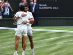 Spain's Carlos Alcaraz with Serbia's Novak Djokovic after winning the final