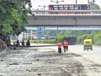 Workers clean the road in front of Monastery Market, in New Delhi on Sunday. (Vipin Kumar/HT) Workers clean the road in front of Monastery Market, in New Delhi on Sunday. (Vipin Kumar/HT)