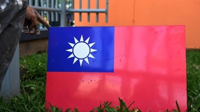 A worker holds Taiwan's flag. (AFP)