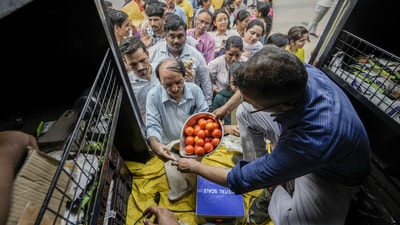 People buy tomatoes at a discounted rate outside Krishi Bhavan in New Delhi (PTI)