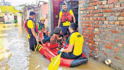 SDRF personnel rescue people trapped in the floodwaters at Laksar in Haridwar district. (PTI) SDRF personnel rescue people trapped in the floodwaters at Laksar in Haridwar district. (PTI)