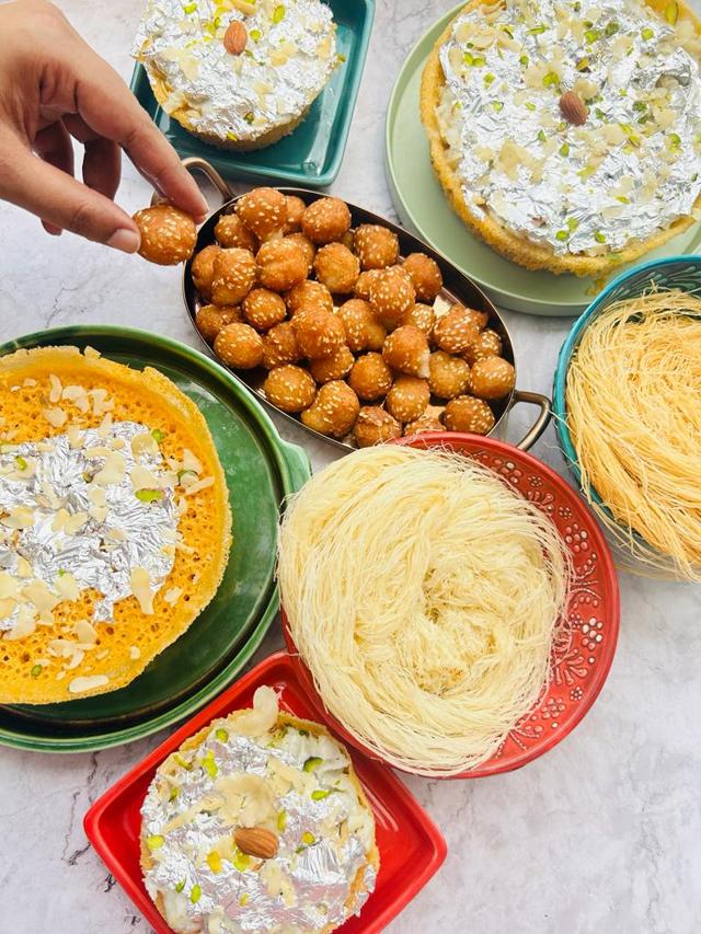 Sawan platter comprising ghewar, doodh pheni and andarsey ki goli Sawan platter comprising ghewar, doodh pheni and andarsey ki goli