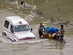 People from low-lying areas relocate to a safer place with their belongings after the Yamuna river inundated the nearby areas during monsoon season at Mayur Vihar in New Delhi on Monday. People from low-lying areas relocate to a safer place with their belongings after the Yamuna river inundated the nearby areas during monsoon season at Mayur Vihar in New Delhi on Monday.