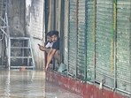 Peopel sit near shops in the flooded Tibetan Market in New Delhi on Monday. (Sanchit Khanna/HT PHOTO) Peopel sit near shops in the flooded Tibetan Market in New Delhi on Monday. (Sanchit Khanna/HT PHOTO)