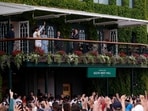 Spain's Carlos Alcaraz celebrates on the balcony with the trophy after winning his final match against Serbia's Novak Djokovic