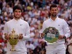 Spain's Carlos Alcaraz poses with the trophy after winning his final match alongside runner up Serbia's Novak Djokovic 