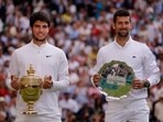Spain's Carlos Alcaraz poses with the trophy after winning his final match alongside runner up Serbia's Novak Djokovic 