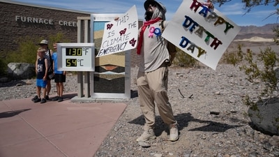 A demonstrator protests visitors to Death Valley National Park, Sunday, July 16, 2023, in Death Valley National Park, California. Death Valley's brutal temperatures come amid a blistering stretch of hot weather that has put roughly one-third of Americans under some type of heat advisory, watch or warning. (AP)