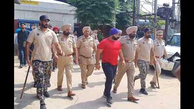 Moga police with gangster Goru Baccha at Moga court complex on Monday.