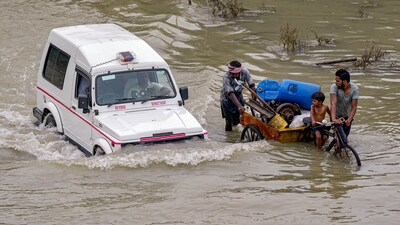 People from low-lying areas relocate to a safer place with their belongings after the Yamuna river inundated the nearby areas during monsoon season at Mayur Vihar in New Delhi on Monday. (PTI) People from low-lying areas relocate to a safer place with their belongings after the Yamuna river inundated the nearby areas during monsoon season at Mayur Vihar in New Delhi on Monday. (PTI)