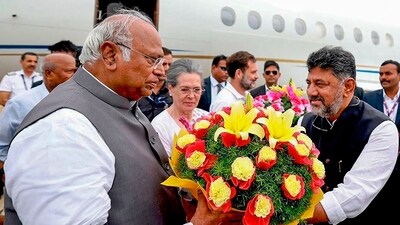 Mallikarjun Kharge and Sonia Gandhi being welcomed by Karnataka DCM DK Shivakumar upon their arrival at HAL airport ahead of the united opposition meeting in Bengaluru on Monday. (PTI) Mallikarjun Kharge and Sonia Gandhi being welcomed by Karnataka DCM DK Shivakumar upon their arrival at HAL airport ahead of the united opposition meeting in Bengaluru on Monday. (PTI)