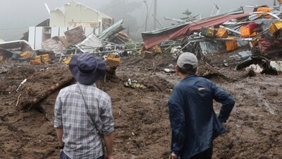 People watch their collapsed houses after a landslide caused by heavy rain in Yecheon, South Korea. (AP) People watch their collapsed houses after a landslide caused by heavy rain in Yecheon, South Korea. (AP)
