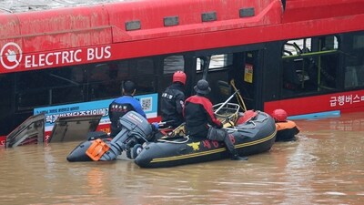 Rescuers conduct a search operation along a road submerged by floodwaters leading to an underground tunnel in Cheongju, South Korea. (AP) Rescuers conduct a search operation along a road submerged by floodwaters leading to an underground tunnel in Cheongju, South Korea. (AP)