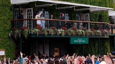 Spain's Carlos Alcaraz celebrates on the balcony with the trophy after winning his final match against Serbia's Novak Djokovic (REUTERS)