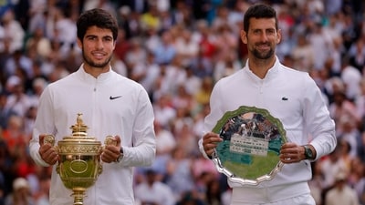 Spain's Carlos Alcaraz poses with the trophy after winning his final match alongside runner up Serbia's Novak Djokovic (REUTERS)
