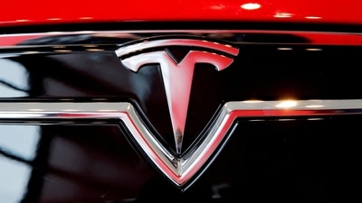 A Tesla logo on a Model S is photographed inside of a Tesla dealership. (REUTERS)
