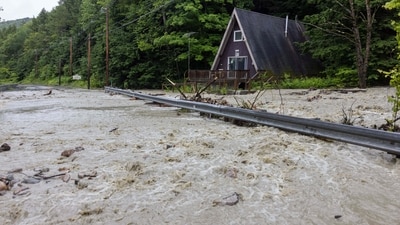 Water floods around a house in Windham, Vermont. Torrential rain and flooding has affected millions of people from Vermont south to North Carolina. (Getty Images via AFP) Water floods around a house in Windham, Vermont. Torrential rain and flooding has affected millions of people from Vermont south to North Carolina. (Getty Images via AFP)