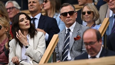 Daniel Craig looked very much in his James Bond character in that suited look and sunglasses as he sat beside wife and actress Rachel Weisz in the royal box at All England Lawn Tennis and Croquet Club in London.&nbsp; (REUTERS)