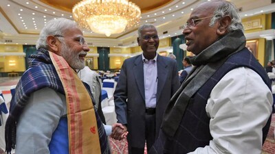 Prime Minister Narendra Modi interacts with Congress president Mallikarjun Kharge. CPI national general secretary D. Raja is also seen. (PTI file) Prime Minister Narendra Modi interacts with Congress president Mallikarjun Kharge. CPI national general secretary D. Raja is also seen. (PTI file)