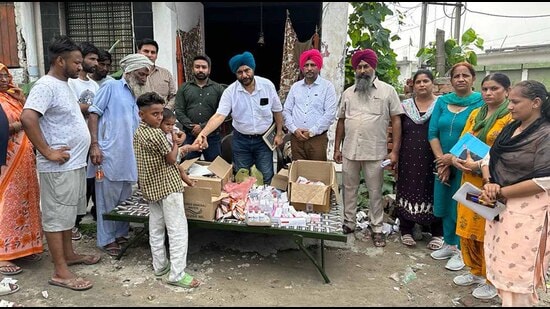 Teams of the health department during a house-to-house survey in one of the flood-affected areas in Ludhiana on Monday. (HT Photo)