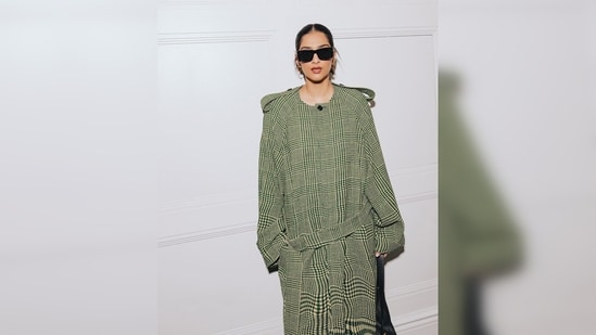 Sonam Kapoor wore a fully checkered trench coat which she teamed with matching tights.&nbsp;(Instagram/@rheakapoor)