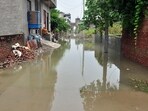 People are forced to remain indoors or to the roof of their houses after water entered their homes in Ghaziabad on Tuesday.