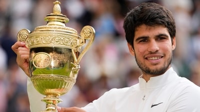 Spain's Carlos Alcaraz celebrates with the Wimbledon trophy (AP)