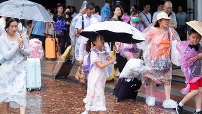 Typhoon Talim: Tourists walk in the rain as Typhoon Talim approaches in Macao in southern China. (AP) Typhoon Talim: Tourists walk in the rain as Typhoon Talim approaches in Macao in southern China. (AP)
