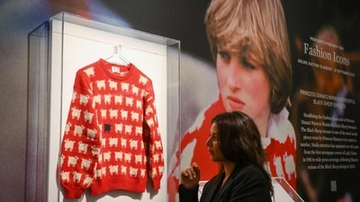 A staff member poses with the "Black Sheep Jumper" designed by Sally Muir and Joanna Osborne and worn on several occasions by Britain's late Princess Diana during a press view. (AFP) A staff member poses with the "Black Sheep Jumper" designed by Sally Muir and Joanna Osborne and worn on several occasions by Britain's late Princess Diana during a press view. (AFP)