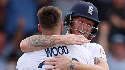 Mark Wood celebrates with Ben Stokes after taking a wicket (Reuters)