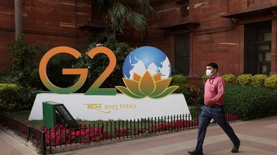 A man walks past a model of G20 logo outside the finance ministry in New Delhi. (REUTERS)