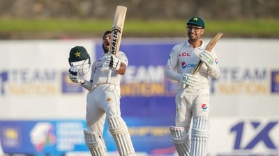 Pakistan's Saud Shakeel, left, celebrates scoring a double century as teammate Abrar Ahmed watches during the third day of the first cricket test match between Sri Lanka and Pakistan (AP)