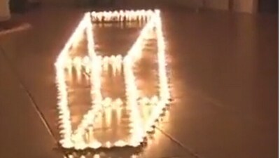 Snapshot of optical illusion made with candles. (Instagram/@Nikola3)