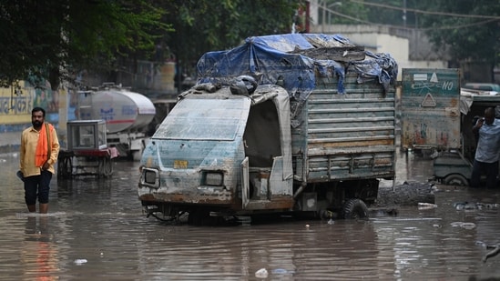 Locals and residents of Yamuna Bazaar area seen clearing the silt deposited in their houses after the Yamuna River levels gets lowered in Delhi.(HT Photo/Sanchit Khanna)