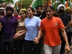 Indian wrestlers Bajrang Punia (L), Vinesh Phogat (2nd L), Sakshi Malik (2nd R) and Sangeeta Phogat (L) attempt to march to India's new parliament