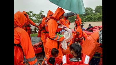 NDRF personnel carry an infant during a rescue operation for people stuck in a flood-hit village in Poladpur, Raigad on Wednesday, (PTI) NDRF personnel carry an infant during a rescue operation for people stuck in a flood-hit village in Poladpur, Raigad on Wednesday, (PTI)