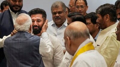 PM Modi hugged Chirag Paswan at the NDA meet in New Delhi on Tuesday. (PTI) PM Modi hugged Chirag Paswan at the NDA meet in New Delhi on Tuesday. (PTI)
