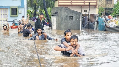 Residents being rescued from a waterlogged area in Saurashtra’s Veraval on Wednesday. (PTI)