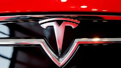 A Tesla logo on a Model S is photographed inside of a Tesla dealership. (REUTERS)