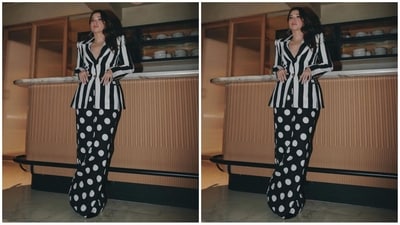 Her chic pantsuit features a black and white striped blazer with a double collar, full sleeves and a fitted bust. She pairs it with flared black trousers featuring white polka dots all over. (Instagram/@tamannaahspeaks) Her chic pantsuit features a black and white striped blazer with a double collar, full sleeves and a fitted bust. She pairs it with flared black trousers featuring white polka dots all over. (Instagram/@tamannaahspeaks)