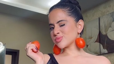 Uoerfi Javed wears tomatoes for earrings.
