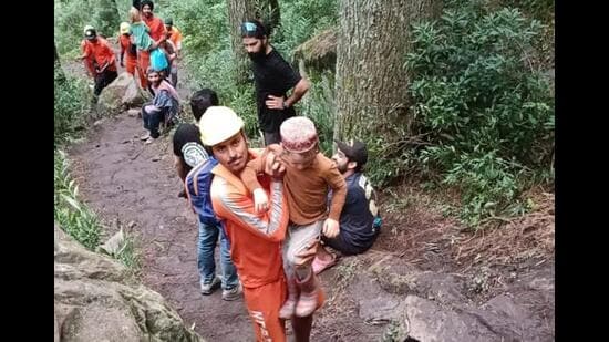 National Disaster Response Force personnel rescuing tourists from Kasol village in Kullu district of Himachal Pradesh. (HT Photo)