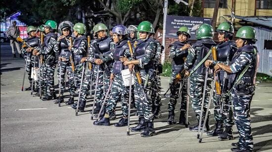 Security personnel stand guard during a protest by women, in Imphal (ANI)