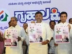 Karnataka Chief Minister Siddaramaiah with Deputy CM DK Shivakumar, Minister Laxmi Hebbalkar and others launch 'Gruha Laxmi' scheme at Vidhana Soudha in Bengaluru on Wednesday. (ANI Photo) Karnataka Chief Minister Siddaramaiah with Deputy CM DK Shivakumar, Minister Laxmi Hebbalkar and others launch 'Gruha Laxmi' scheme at Vidhana Soudha in Bengaluru on Wednesday. (ANI Photo)