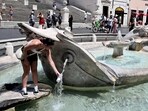 A woman fills a bottle with water at the Barcaccia fountain in front of the Scalinata di Trinita dei Monti (Spanish Steps) in Rome during a heatwave in Italy earlier this month. Unforgiving heat scorched parts of the Northern Hemisphere, triggering health warnings and fanning wildfires in the latest stark reminder of the effects of global warming. A woman fills a bottle with water at the Barcaccia fountain in front of the Scalinata di Trinita dei Monti (Spanish Steps) in Rome during a heatwave in Italy earlier this month. Unforgiving heat scorched parts of the Northern Hemisphere, triggering health warnings and fanning wildfires in the latest stark reminder of the effects of global warming.