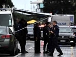 Police officers cordon off an area near the site of a shooting in central Auckland on July 20, 2023.