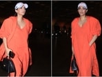 Sonam Kapoor wears a maxi dress, sneakers, and a baseball cap to the airport. 