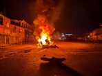 Tyres and construction materials set on fire by miscreants amid ongoing ethnic violence in Manipur, in Imphal East district, Friday. (PTI)